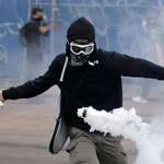 image for Protestor returns tear gas with tennis racket