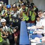 image for Hong Kong press wears helmets, eye masks and reflective vests to express discontent towards local police's actions.