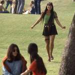 image for A Southern California high school student walks toward classmates while wearing the “Mini Jupe” skirt, 1969