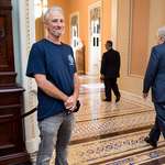 image for John Stewart smiles as Senate Majority Leader Mitch McConnell walks by in the Capitol before voting later today on the Permanent Authorization of the September 11th Victim Compensation Fund Act