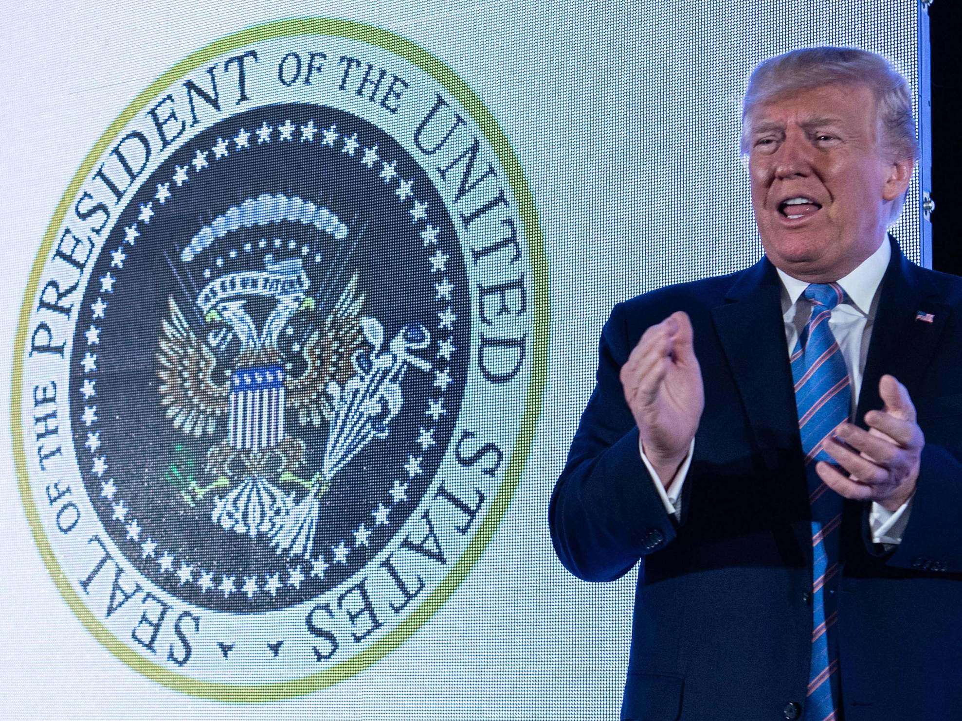 image for Trump speaks in front of fake presidential seal mysteriously manipulated to feature Russian eagles and golf clubs