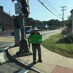 image for Nearly every day this elderly women stands with this sign up, facing the traffic.