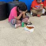 image for Distressed child spending the night in a gym after her parents were taken away by an ICE raid in Mississippi