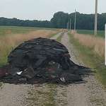image for I guess this county road is as good a place as any to dump the leftover scrap from a roofing job.