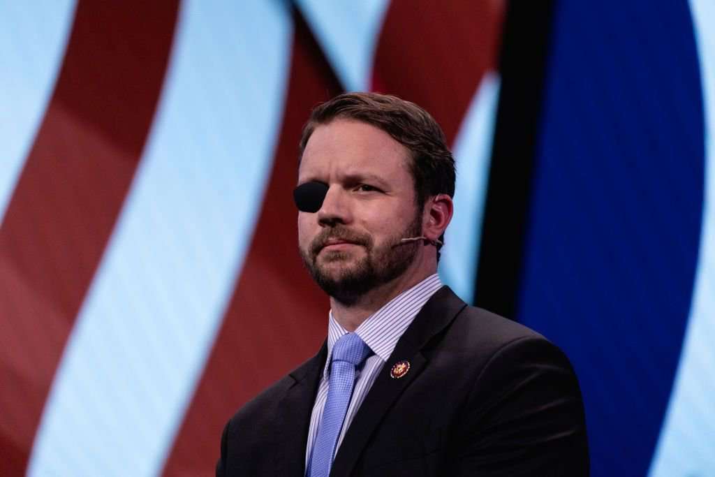 image for Dan Crenshaw is worried that universal background checks might keep him from arming his friends