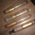 image for Found buried in a pit dug in Yankton, SD, where an old hotel used to be prior to 1875. The "vials" must be broken open, and inside the golden capsules are a piece of paper with a number on it.