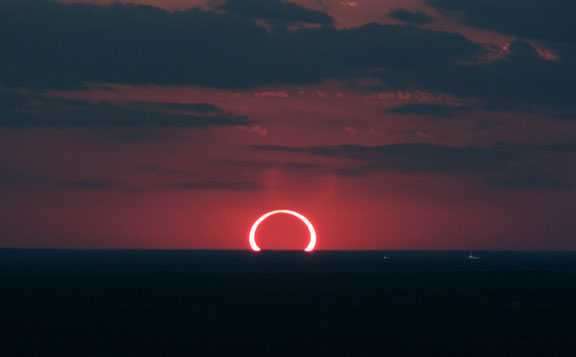 image showing Ever seen a sunset and a solar eclipse at the same time? Well, now you have.