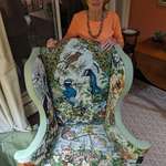 image for My 86yo grandmother and her handmade needle point chair. 25 years in the making and 14 threads per inch. She used to pick up road kill from the side of the road to compare thread colours. She also bought a peacock for colour comparison. I am not allowed to sit in it.