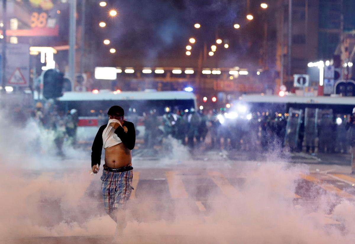 image for Hong Kong enters recession, official says, as protests again erupt in flames