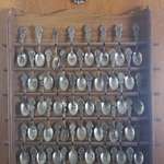 image for My aunt has a spoon collection that has a tiny spoon collection right above it.