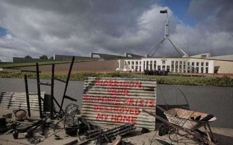 image for Grandmother dumps burnt remains of home at Parliament House in climate change protest