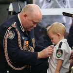 image for The young son of a volunteer killed fighting NSW bushfires receives a medal for his father's bravery during an emotional funeral service.