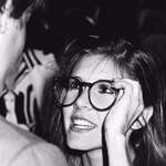 image for Carrie Fisher trying on Harrison Ford's glasses. 1983