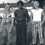 image for A punk, a “rude boy” and a skinhead hanging out together in England c. 1980.