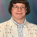 image for School photo looking like 60-year old librarian with my cardigan, turtleneck and thick glasses Date and age unknown.