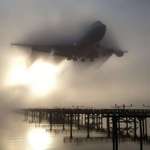 image for 747 breaking through morning fog.