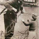 image for An East German soldier ignores orders to let no one pass and helps a boy, who was found on the opposite side from his family, cross the newly formed 'Berlin Wall'- 1961