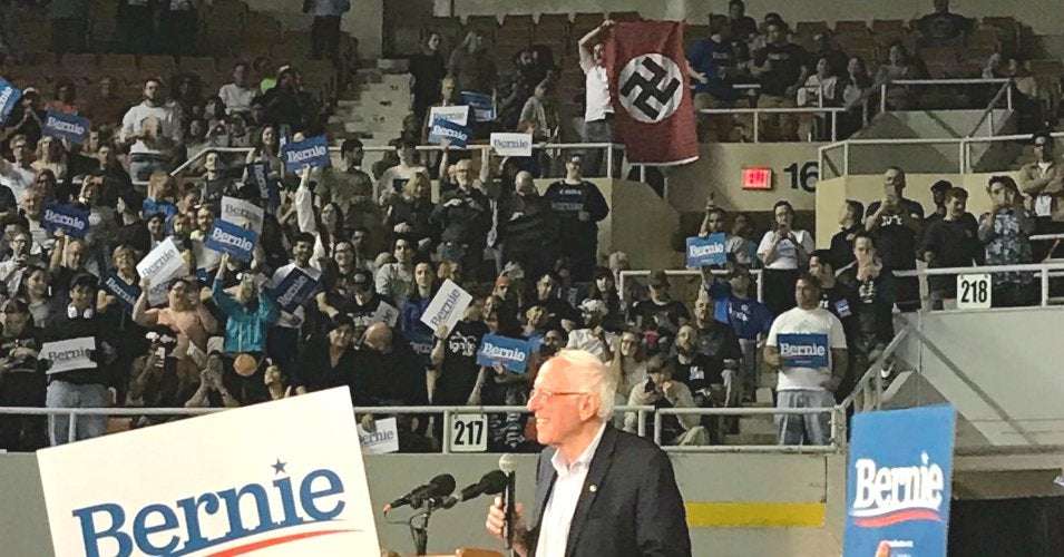 image for 'Absolutely Sickening—and Scary': Man Unfurls Nazi Flag at Bernie Sanders Rally, Heightening Security Concerns