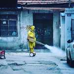 image for Worker spraying the streets to prevent Covid 19. This is the most cyberpunk picture I've ever seen.