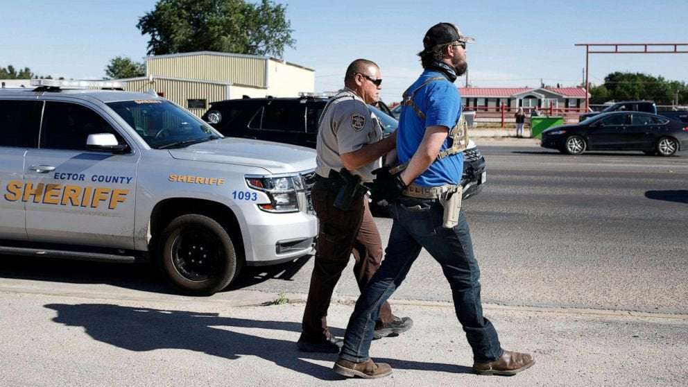 image for Cops arrest armed men, Texas bar owner who violated order to close