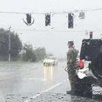image for A funeral procession drove past and this solider left his car to stand at attention in the rain.