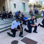 image for The police taking a knee with protesters in Miami, Florida