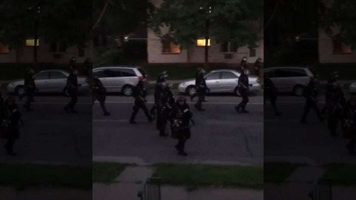 image for Video: Law enforcement fires paint projectile at residents on porch during curfew in Minneapolis