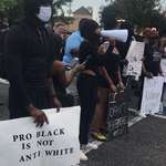 image for 'Pro Black Is Not Anti White' reads a protestor's sign at a demonstration for George Floyd in LA