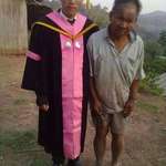 image for Graduated son taking a picture with his farmer father