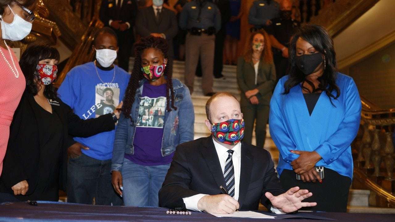 image for Colorado governor signs police accountability bill, ending qualified immunity defense in the state
