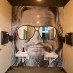 image for This bathroom hand washing area with mirrors in the shape of sunglasses.