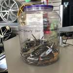 image for Local tire shop has a jar full of various things they’ve found inside of popped tires.