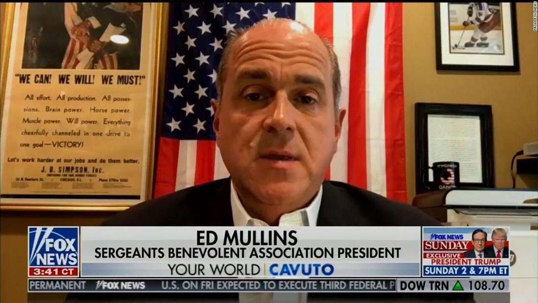 image for Head of NYPD union gives Fox News interview with QAnon mug in background
