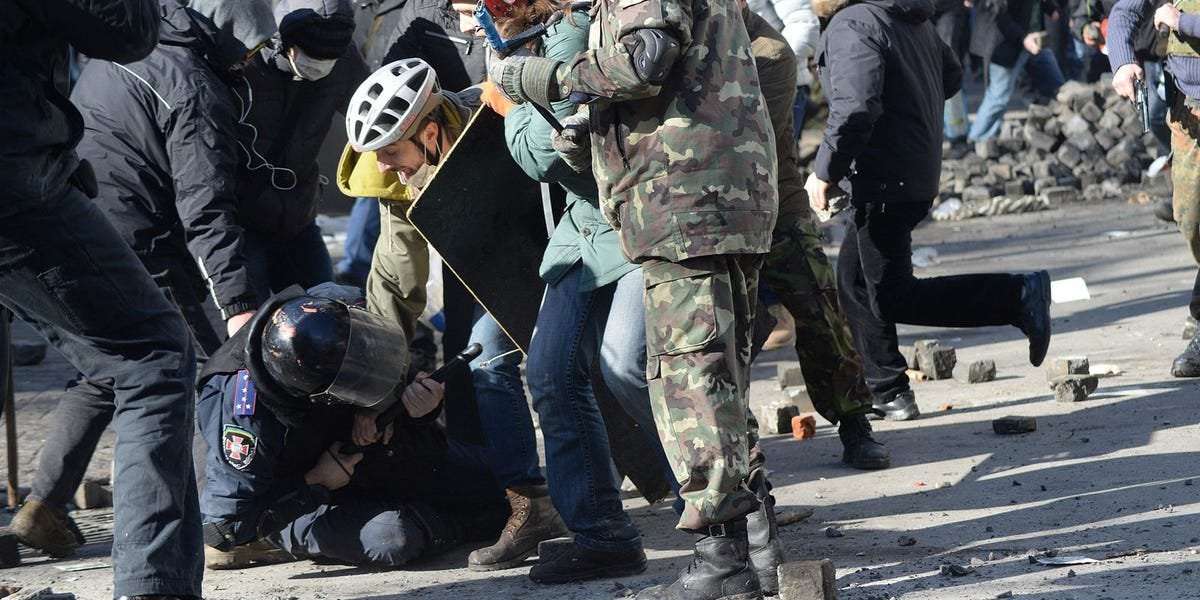 image for A new Trump campaign ad depicting a police officer being attacked by protesters is actually a 2014 photo of pro-democracy protests in Ukraine