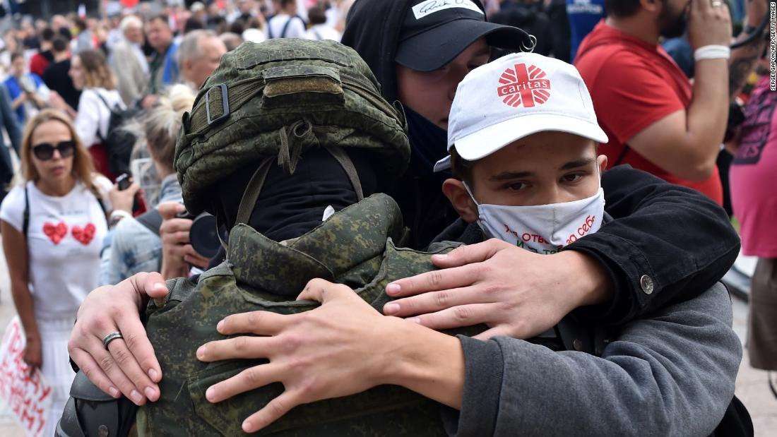 image for Belarus riot police drop shields and are embraced by anti-government protesters