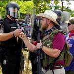 image for Cop fist-bumps armed Nazi “militia member” at Stone Mountain, GA rally (Reuters)