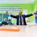 image for Former French Prime Minister Édouard Philippe defeats children in a game of dominoes during a visit to a school, September 2019
