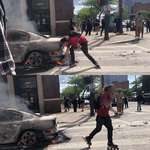 image for Guy lighting his blunt from the flames of a burning police car... On rollerblades. You’re welcome.
