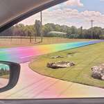 image for The sun hit this freshly-paved tarmac just right and made a real-life Rainbow Road through polarized lenses.