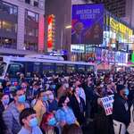 image for Crowd in Times Square standing in silence listening to President-elect Biden address the nation.