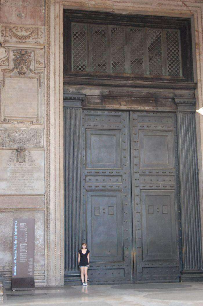 image showing The oldest doors in Rome, dating back to 115 AD. Human for scale.