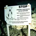 image for An eerie underwater cave death warning sign.