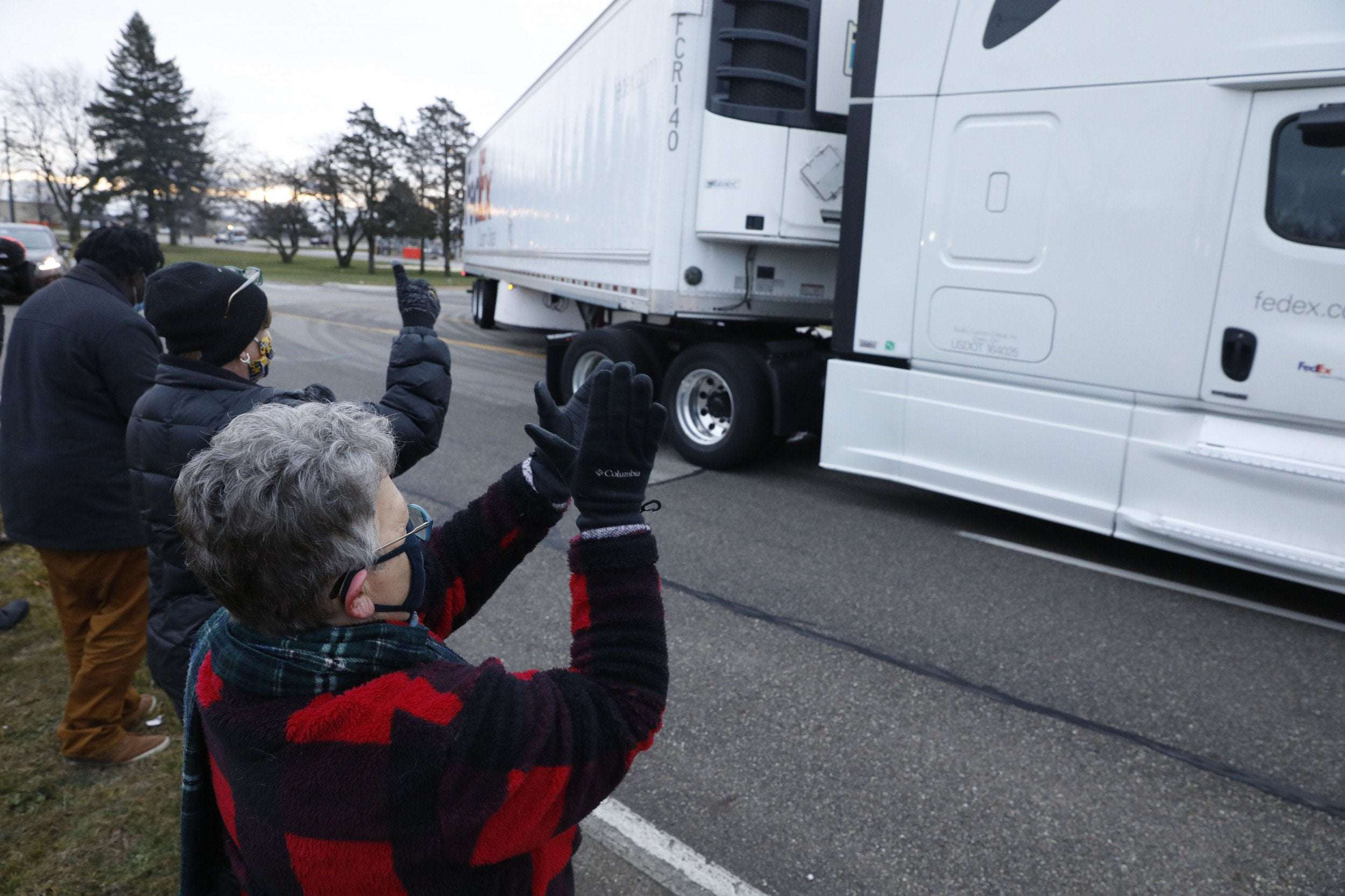 image for Trucks Carrying Pfizer COVID Vaccine Met by Cheering Onlookers at Kalamazoo Warehouse