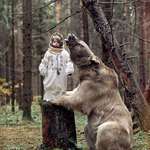 image for Little girl poses with 50 STONE grizzly bear after it was adopted as a cub and brought up by Russian family.