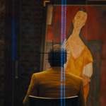 image for In Skyfall (2012), a stolen painting is being shown to a man. The painting is ‘Woman with a fan’ by Amadeo Modigliani. It was stolen in real-life in 2010 and has yet to be recovered.