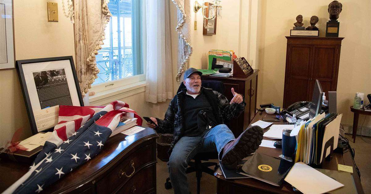 image for Man pictured with foot on desk in Pelosi's office is arrested