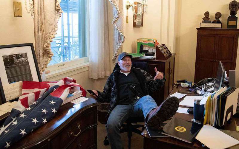 image for Man pictured with foot on desk in Pelosi's office is arrested