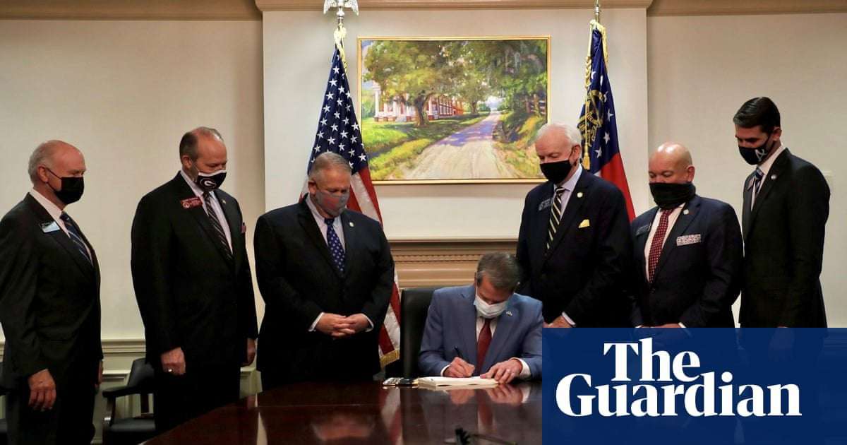 image for Georgia's governor signed 'Jim Crow' voting bill under painting of a slave plantation