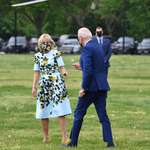 image for Joe Biden hands a dandelion to the First Lady Jill on the way to Marine One today