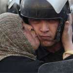 image for Egyptian woman kisses a policeman that refused to fire on protestors.